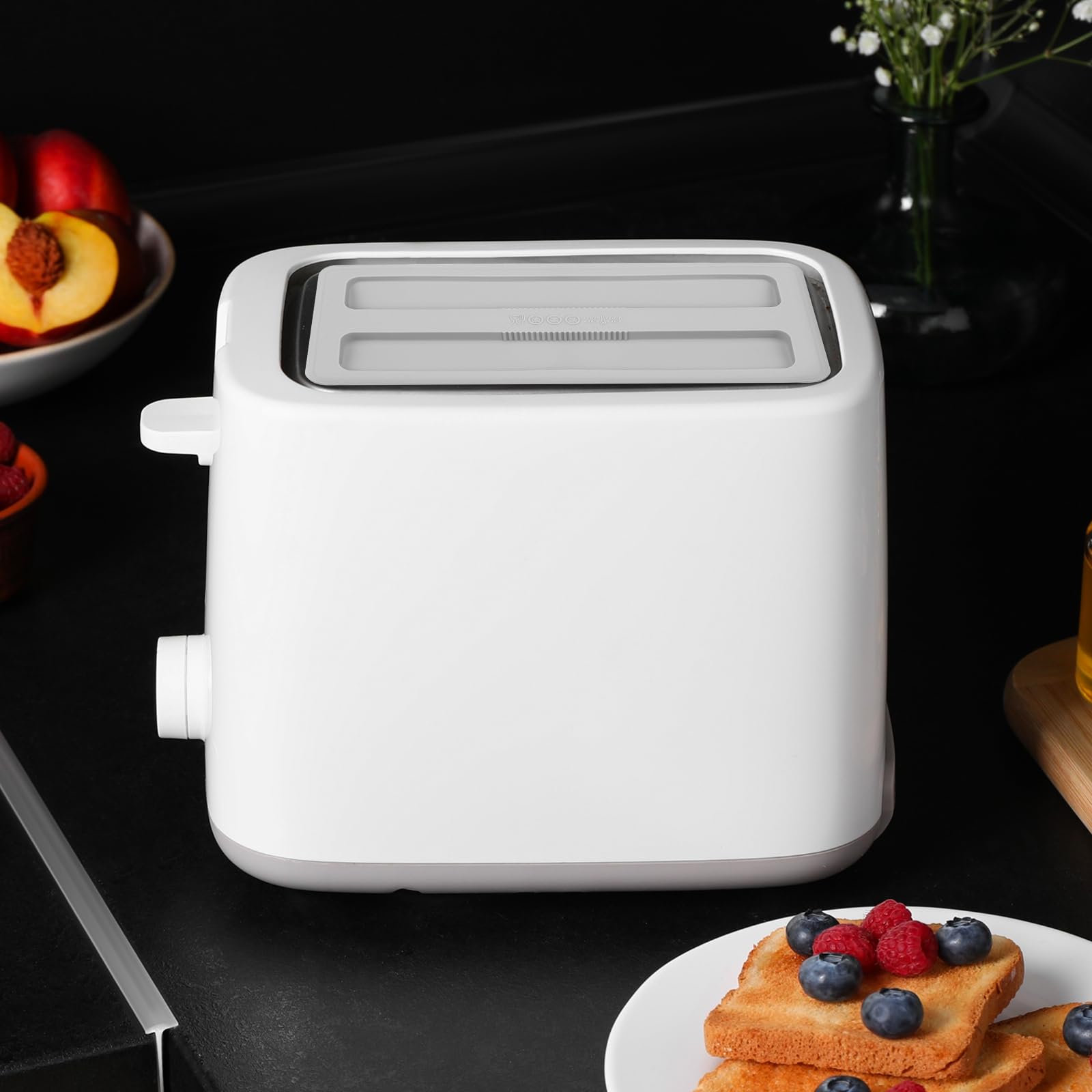 Kichvoe silicone toaster lid shields against kitchen splashes.