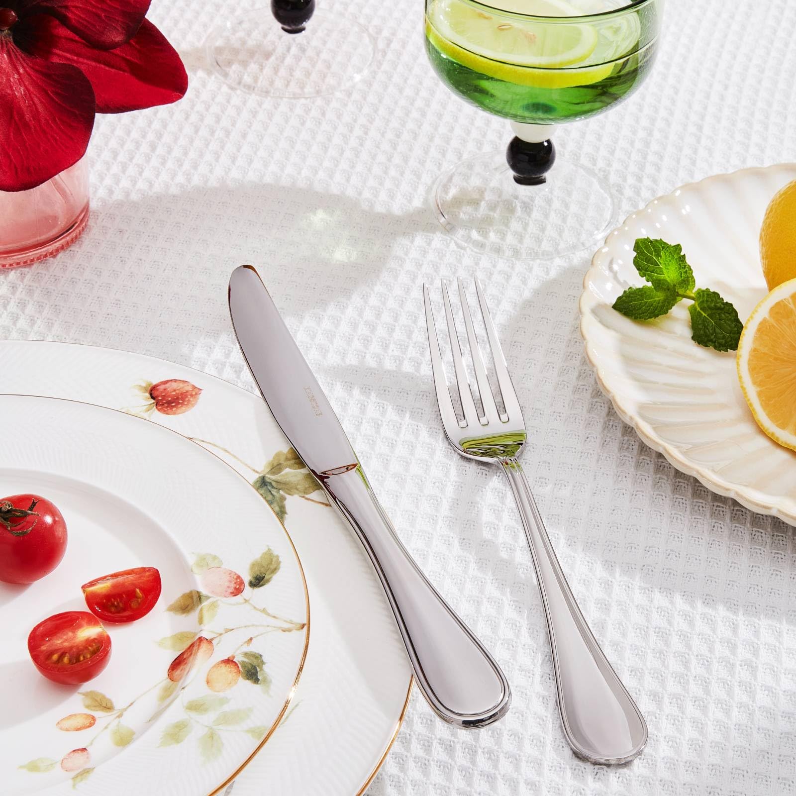 KINGSTONE dinner spoons and knives arranged for an upscale table setting