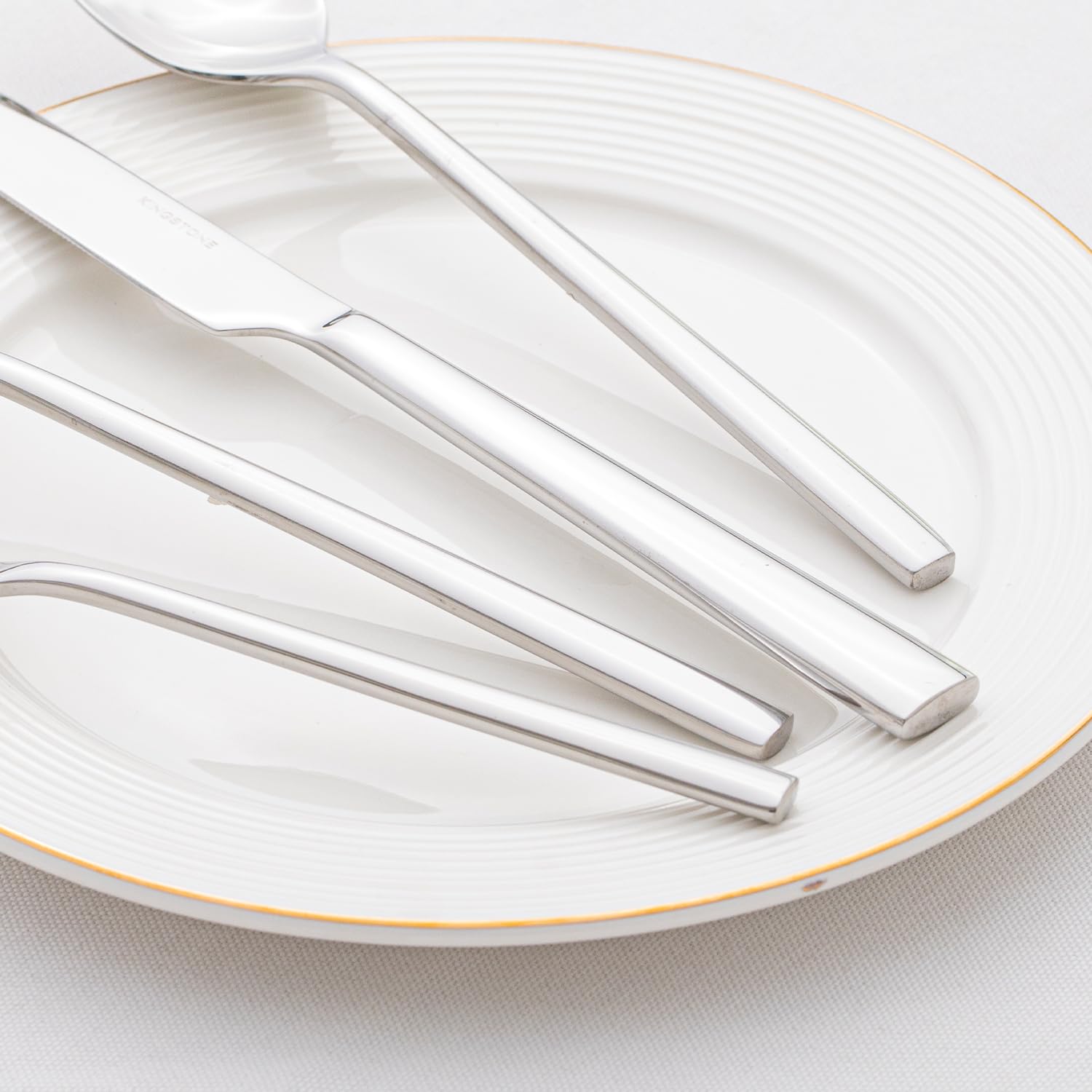 Kingstone mirror-polished finish detail showcases sleek, elegant dining ware.