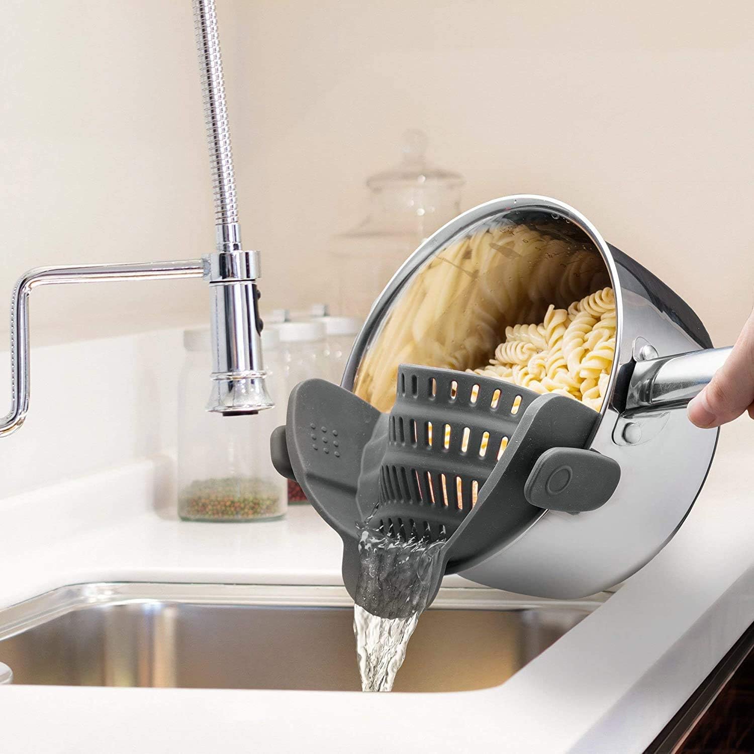 Kitchen Gizmo Snap N' Strain clip-on on a pot for hands-free draining.