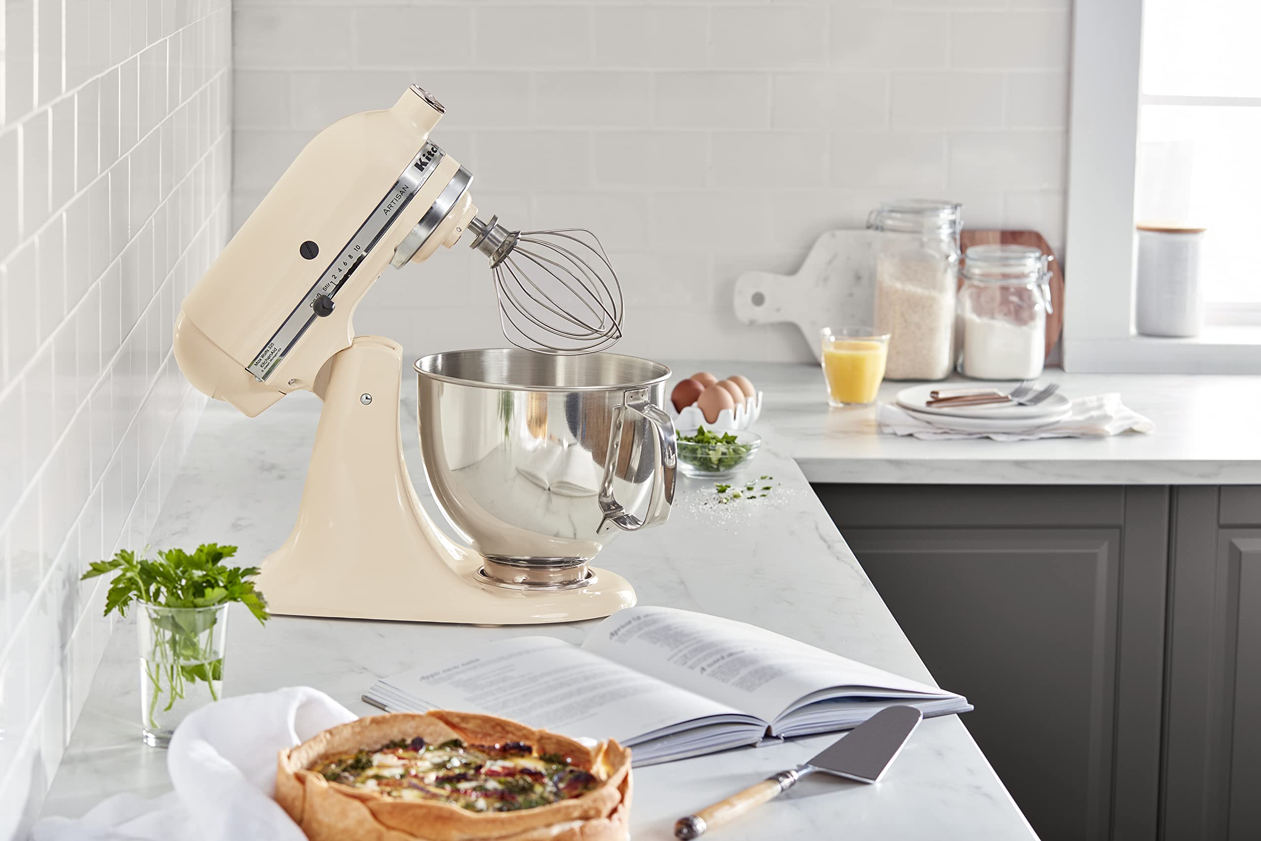 KitchenAid Artisan mixer with 10 speeds for precise doughs, batters, and creams.