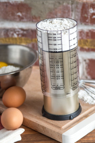 KitchenArt Pro 2 Cup Adjust-A-Cup plunger in action for sticky ingredients.