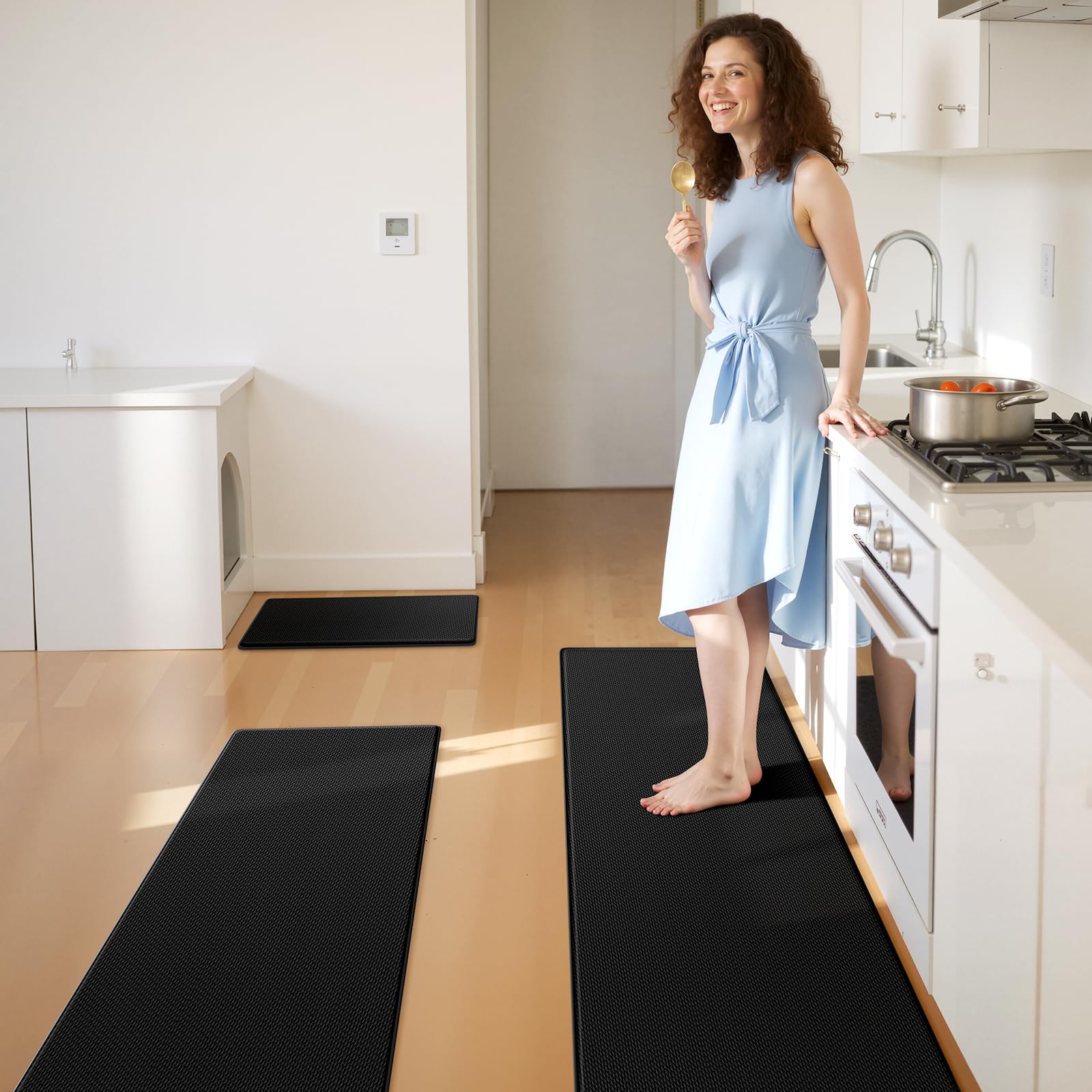 KitchenClouds waterproof sink mat protects countertops while catching spills and crumbs.