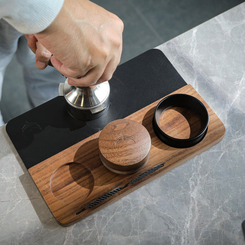 KNODOS compact tamping station fits neatly into busy espresso setups.