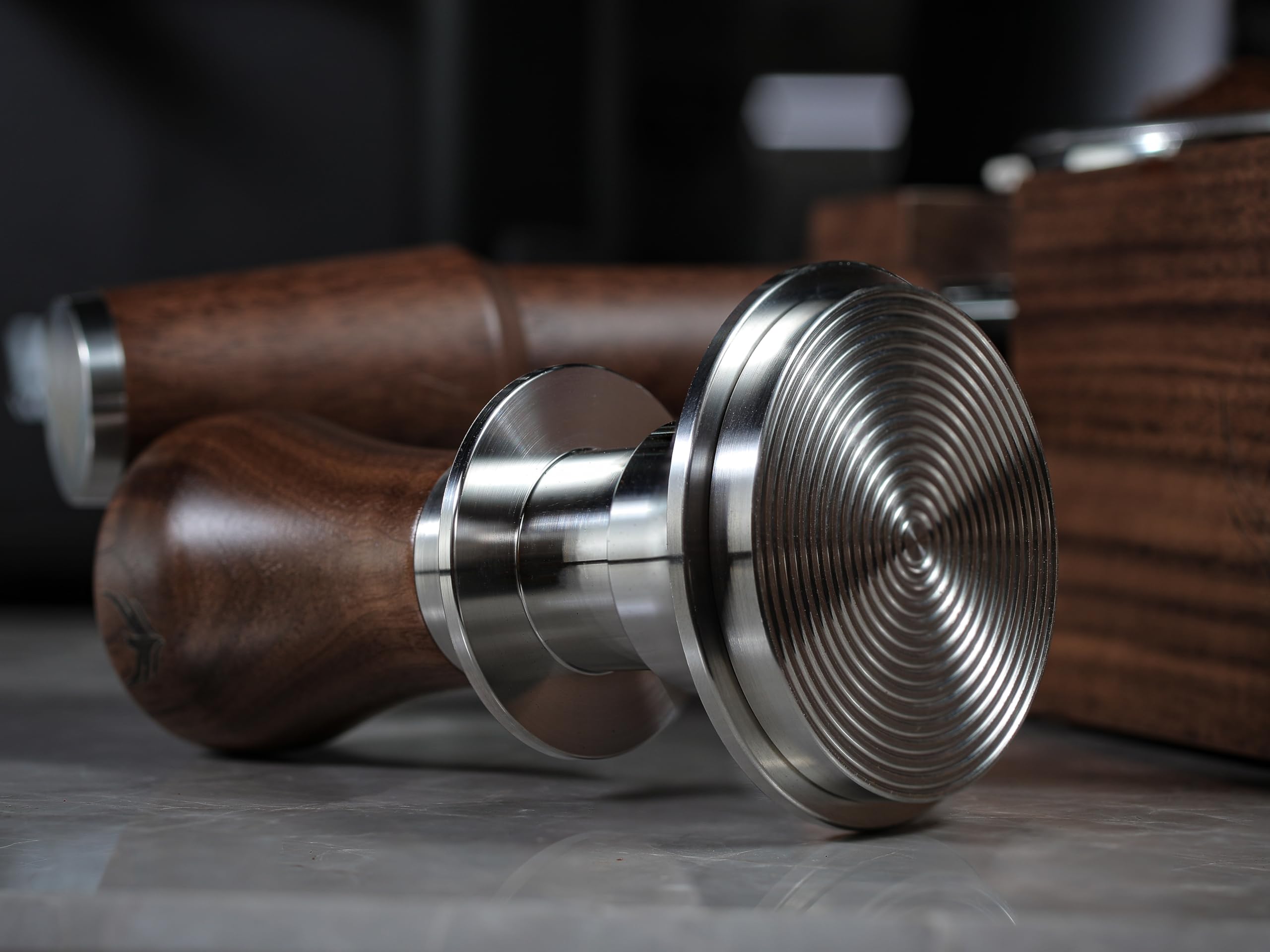 Gift-packaged tamper with portafilter-shaped keychain accessory.