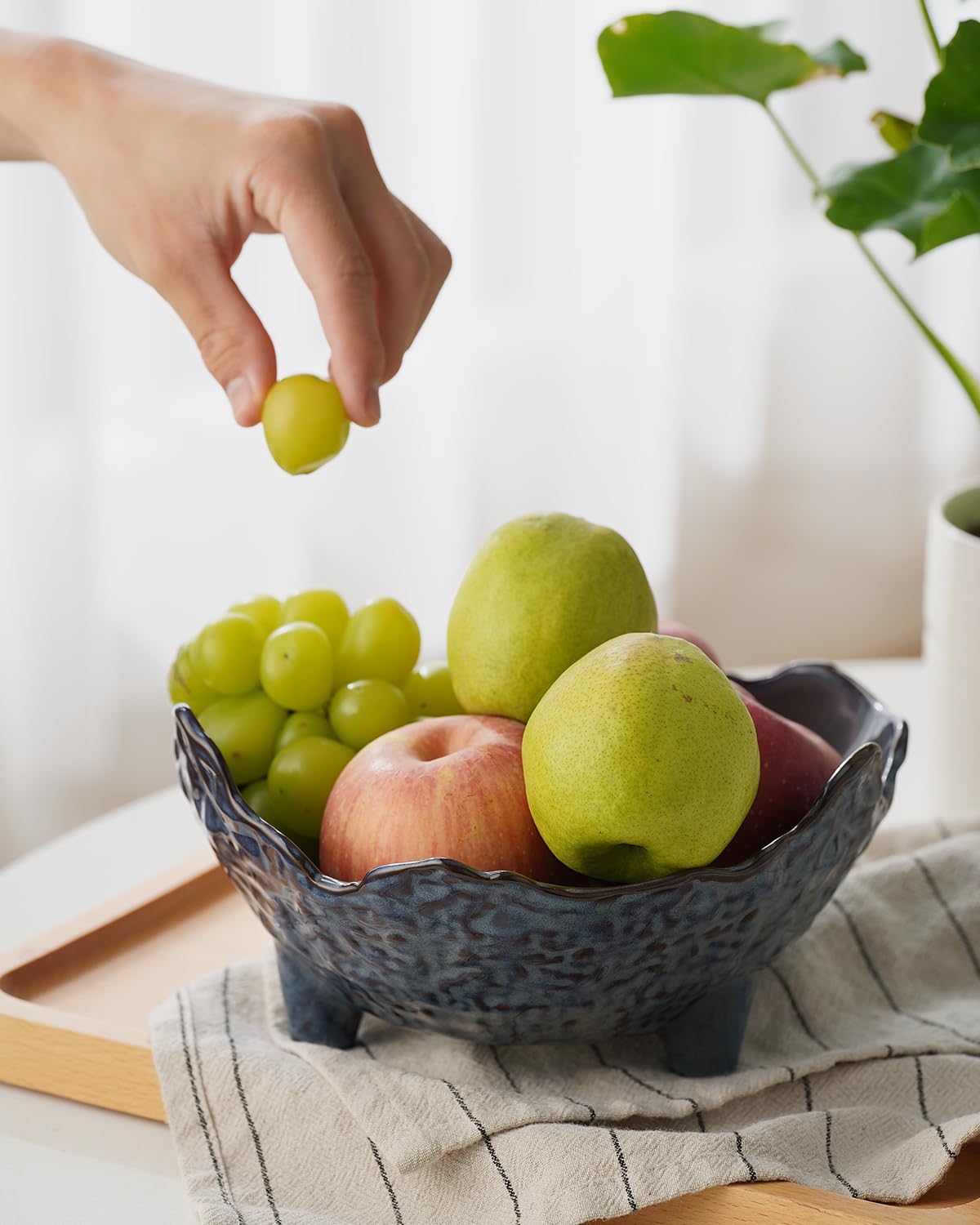 KOKUNKA blue porcelain bowl holds vegetables and seasonal treats.