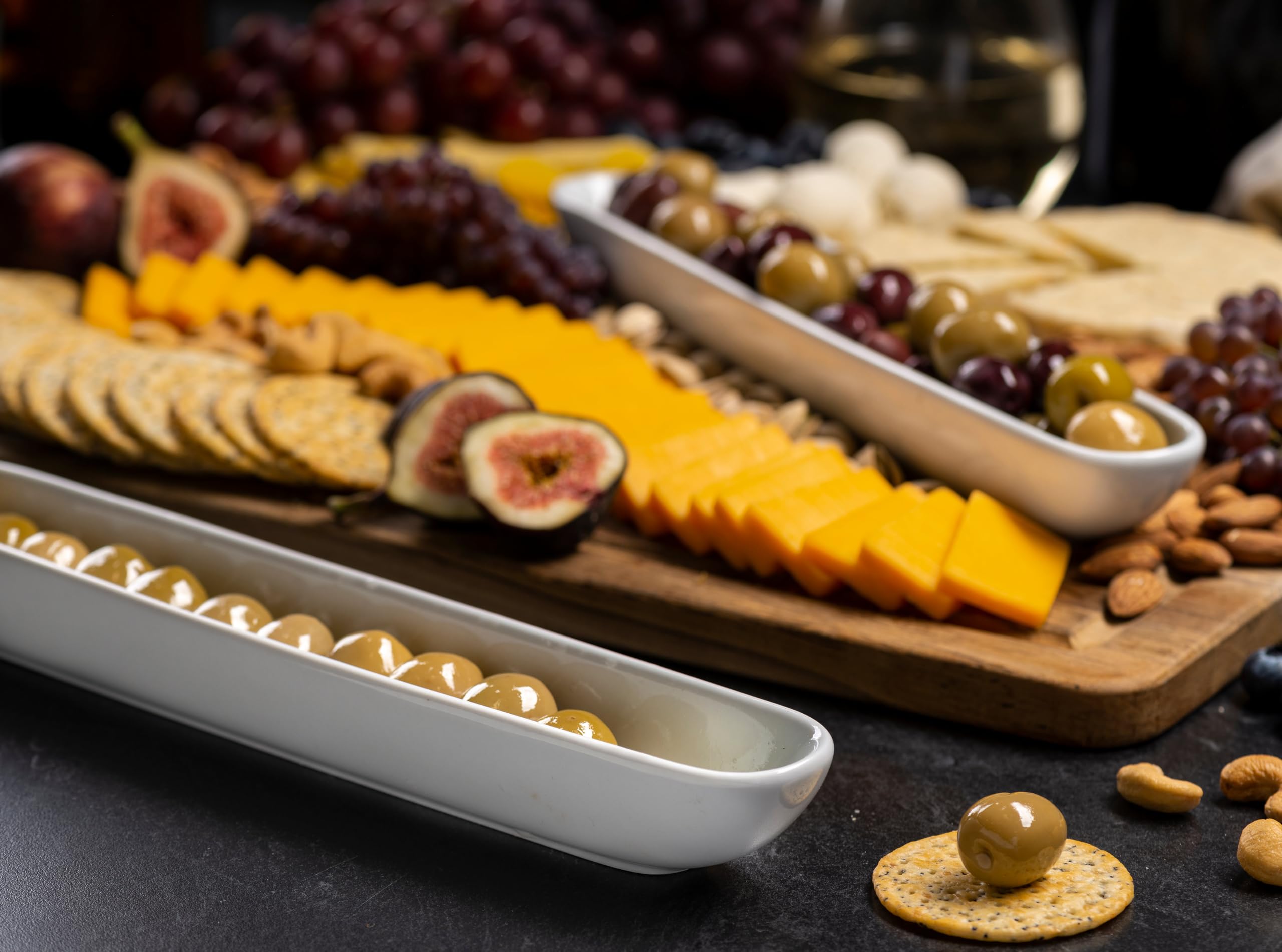12 inch long and narrow KooK Olive Boat Tray on a charcuterie board