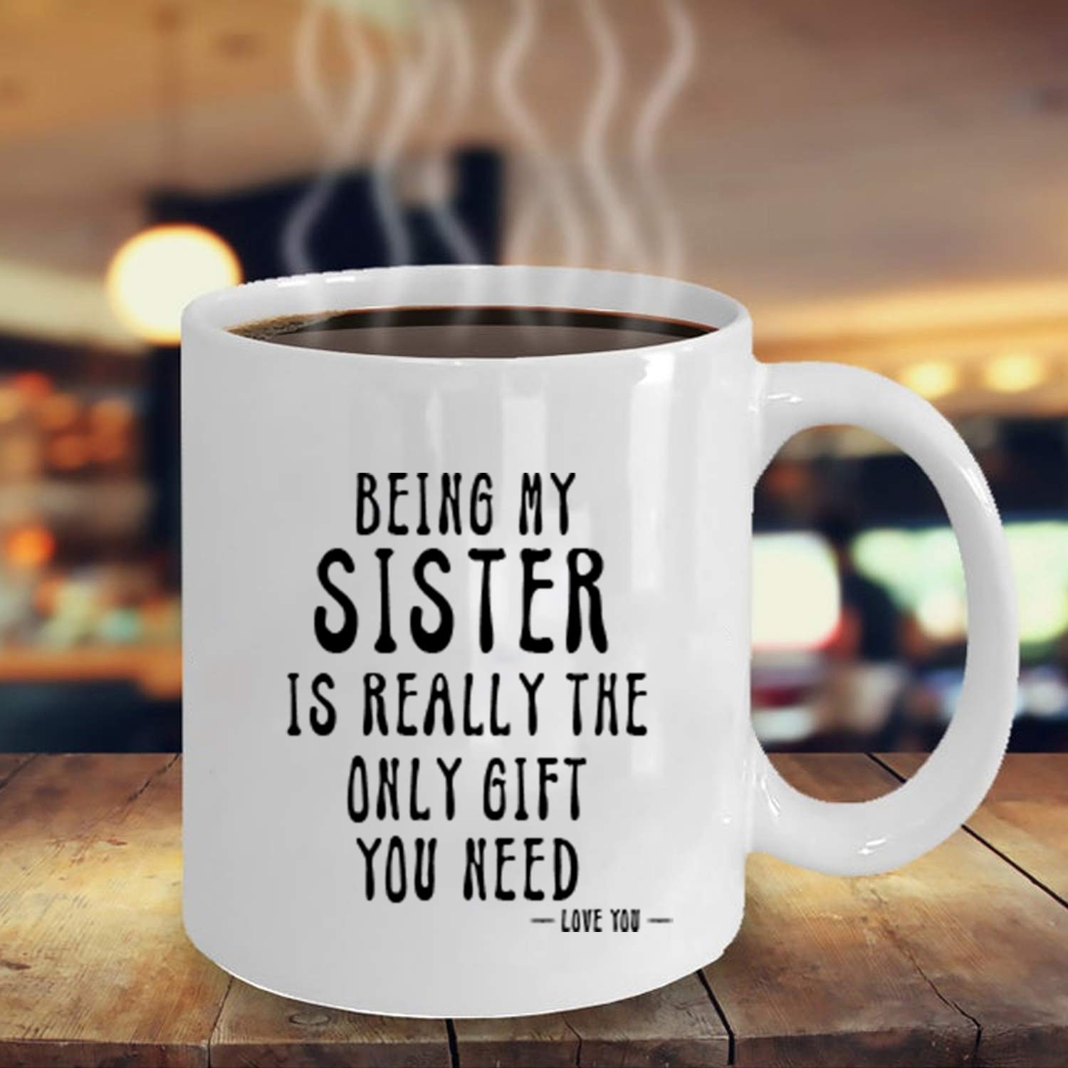 Kropsis Being My Sister mug in use with coffee