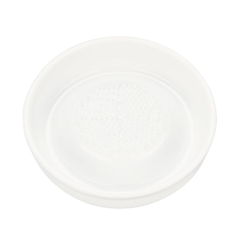 Kyocera 3.5-inch ceramic ginger grater in action for fresh flavor.