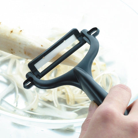 KYOCERA peeler in use with vegetables showing effortless, clean slices