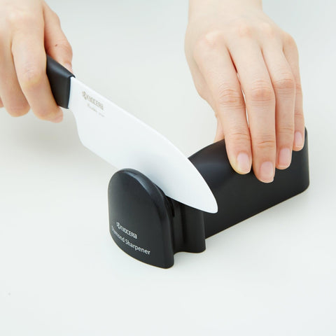 KYOCERA sharpener in use sharpening a metal knife for precise edge restoration