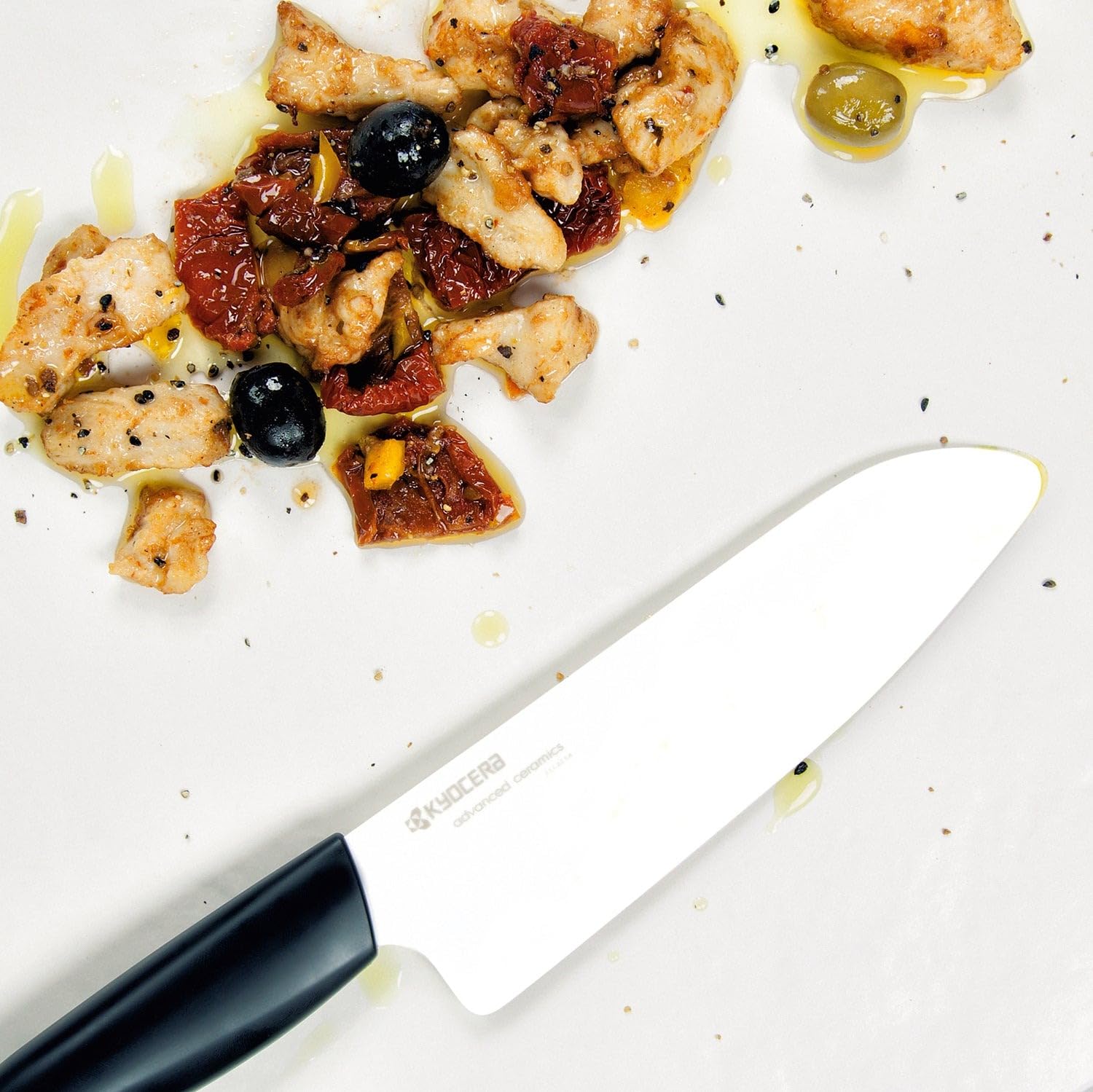Kyocera FK-140-WH Santoku in a kitchen scene ready for everyday prep tasks