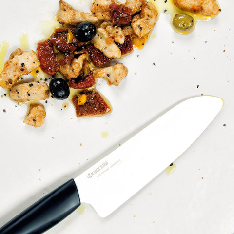 Kyocera FK-140-WH Santoku in a kitchen scene ready for everyday prep tasks