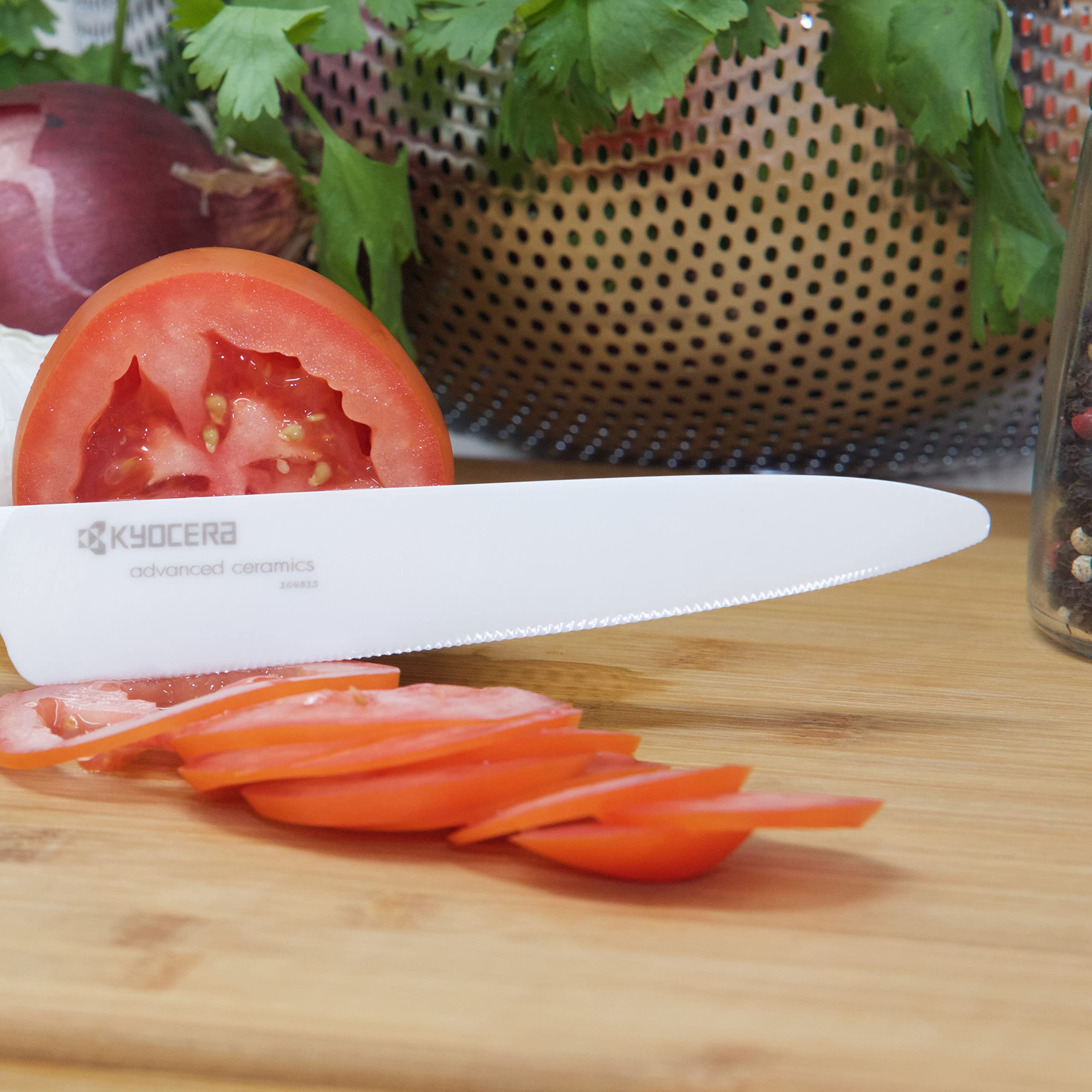 KYOCERA knife set with red handles displayed in block demonstrates balanced handling.