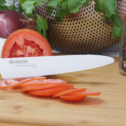 KYOCERA knife set with red handles displayed in block demonstrates balanced handling.