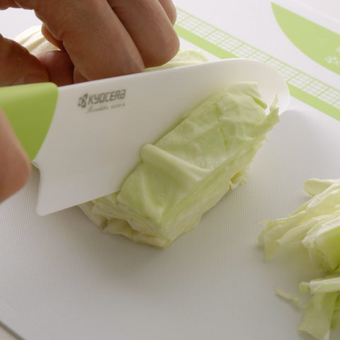 KYOCERA Revolution 4.5-inch utility knife in action slicing fruit