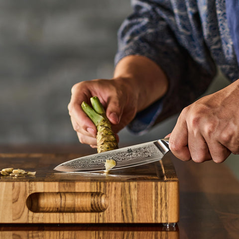 KYOKU knife in use slicing vegetables with effortless control.