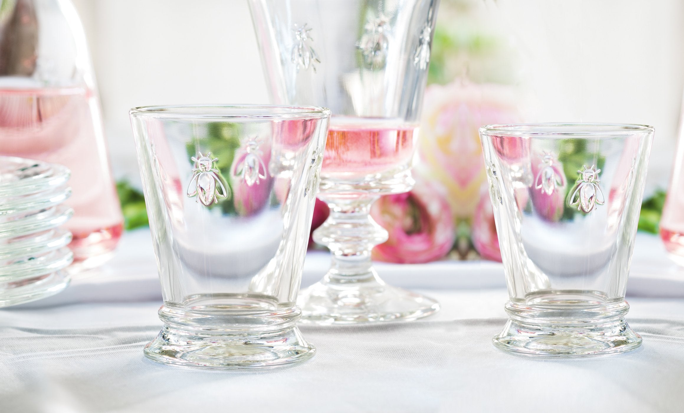 Bee emblem detail on La Rochere tumbler highlighting heritage design.