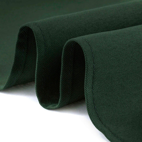 Hunter green round tablecloth draped for a wedding reception by Lann's Linens.