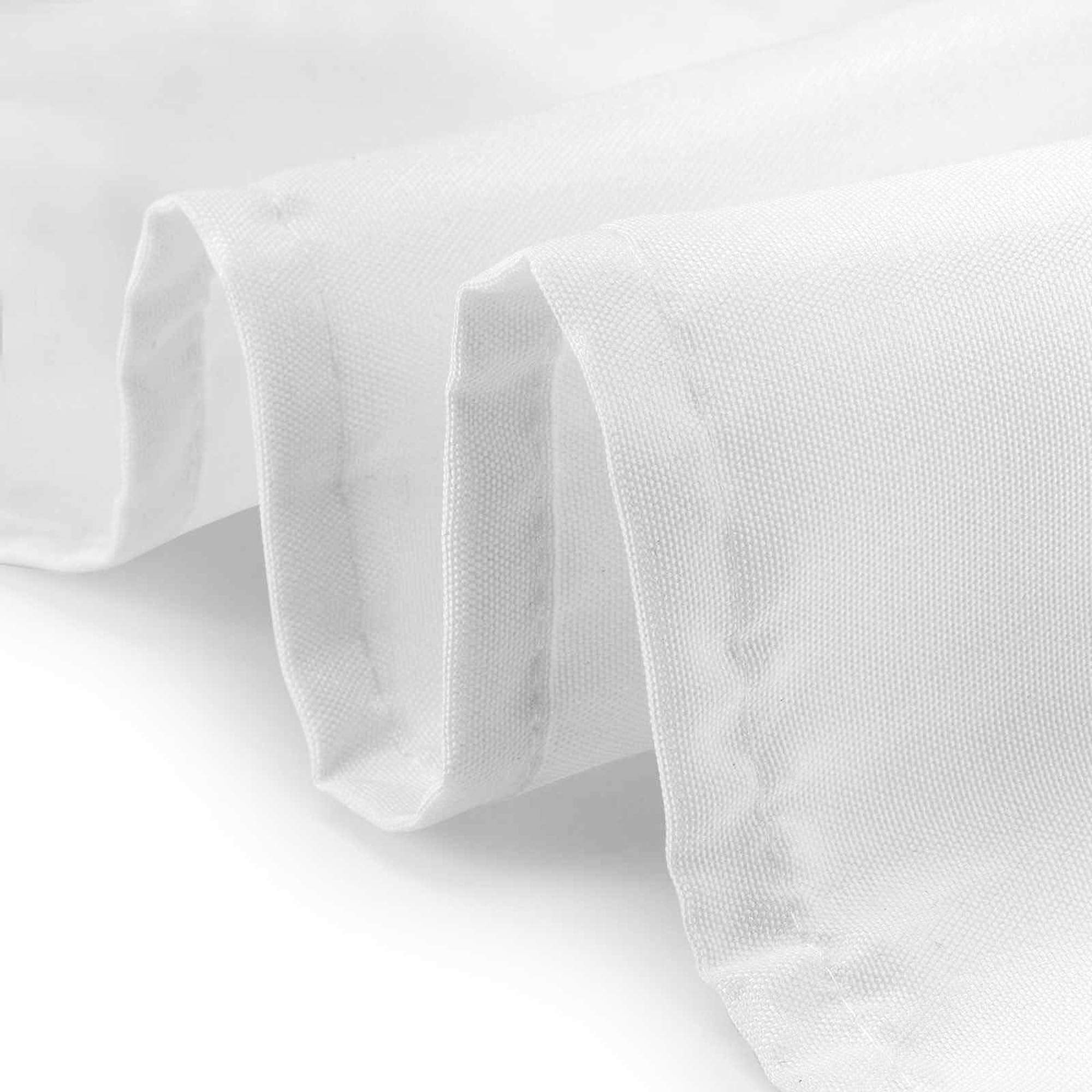 Wedding-ready white tablecloth on elegant event setup.