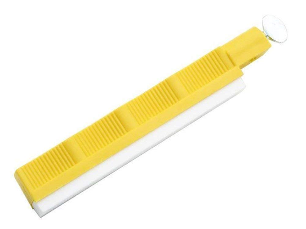 Close-up of yellow holder stabilizing the hone during sharpening.
