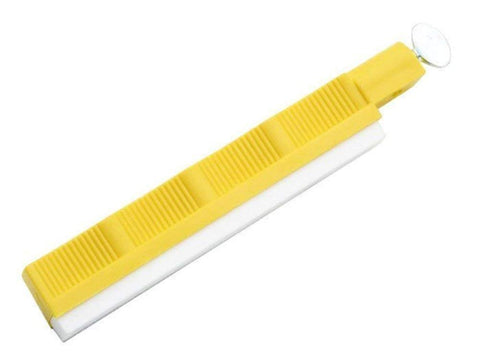 Close-up of yellow holder stabilizing the hone during sharpening.