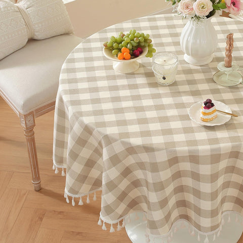 Laolitou beige checkered round tablecloth laid on a round dining table.