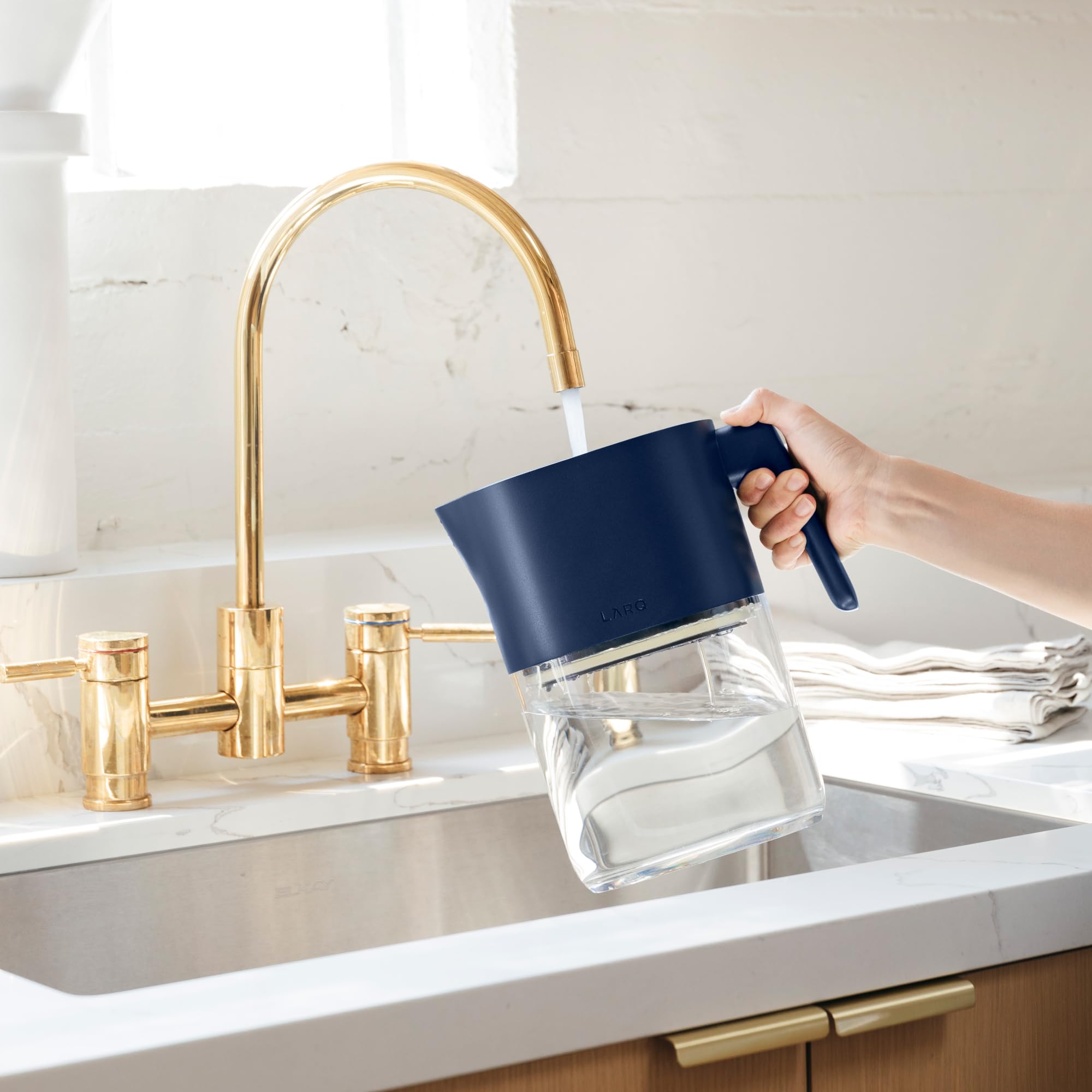 LARQ PureVis Monaco Blue pitcher on a modern kitchen counter.