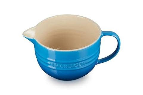Le Creuset batter bowl handle detail for precise pouring control.