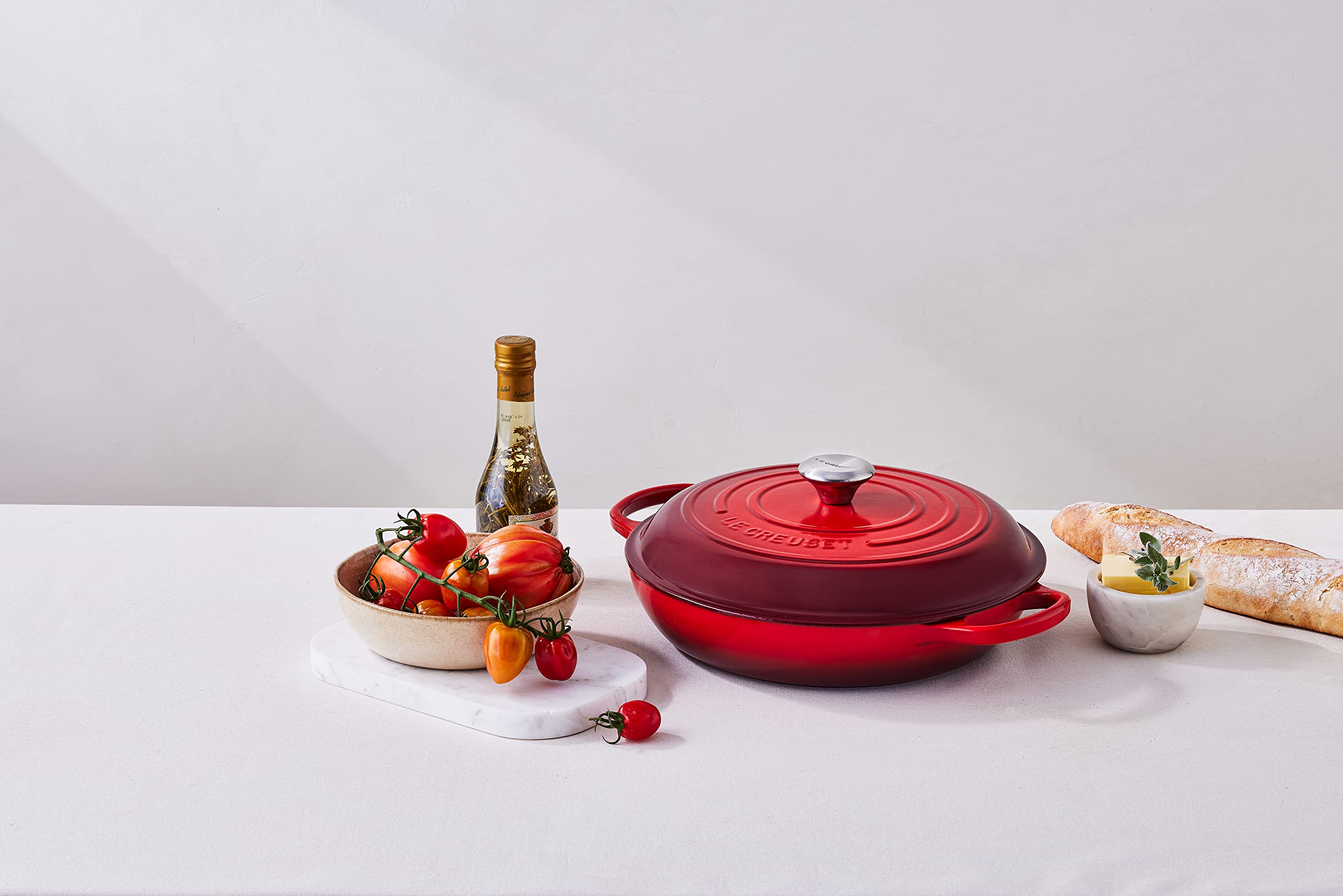 Le Creuset braiser cerise on table, ready for serving.
