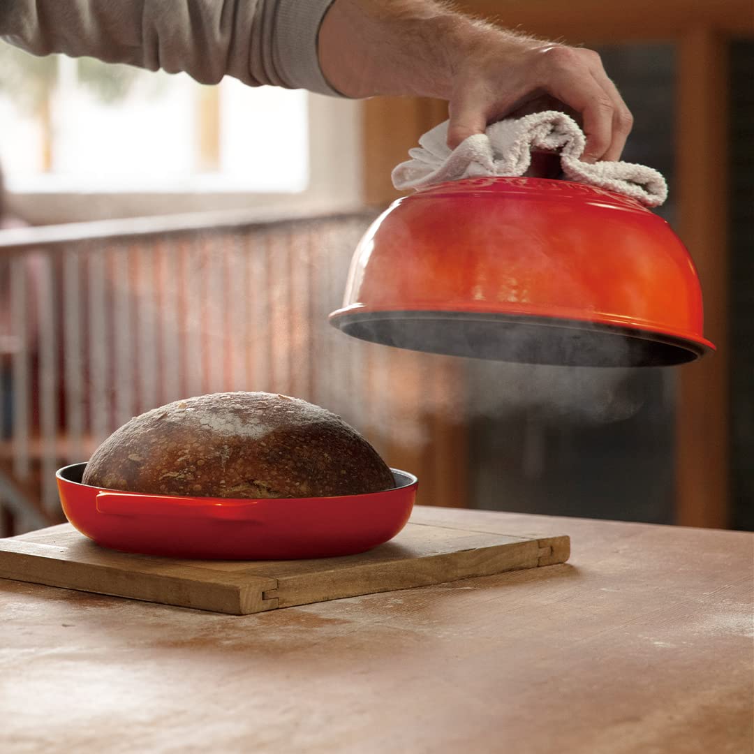 Le Creuset Bread Oven Flame interior enamel resists sticking and cleans easily.