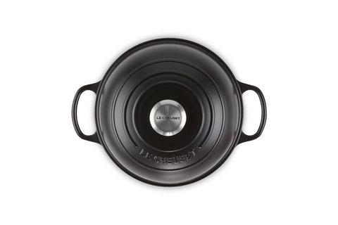 Le Creuset lid traps steam for crisp crust and maximum rise.