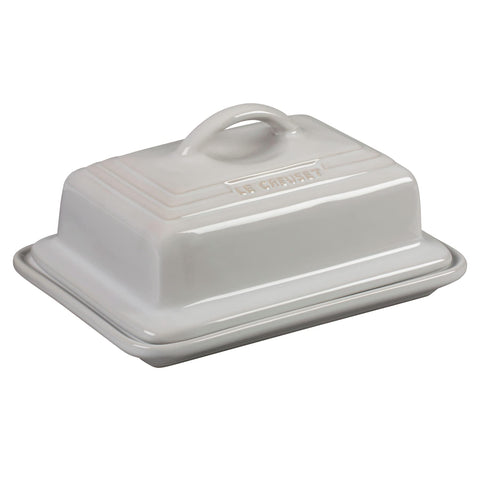 Le Creuset butter dish in white with lid on, ideal for fridge-to-table use.