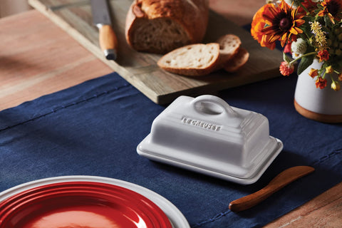 Le Creuset butter dish close-up shows durable white stoneware glaze.