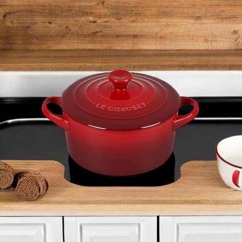 Cerise color pop from Le Creuset cocotte brightening kitchen display