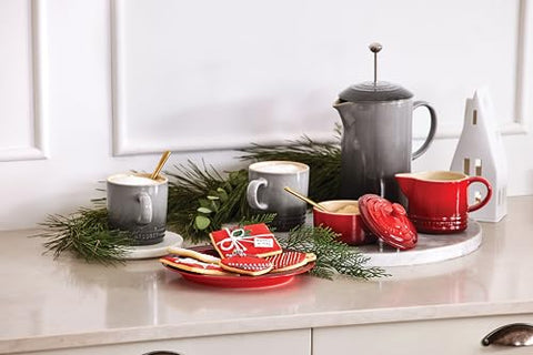 Cerise Le Creuset stoneware set used daily in kitchen setting