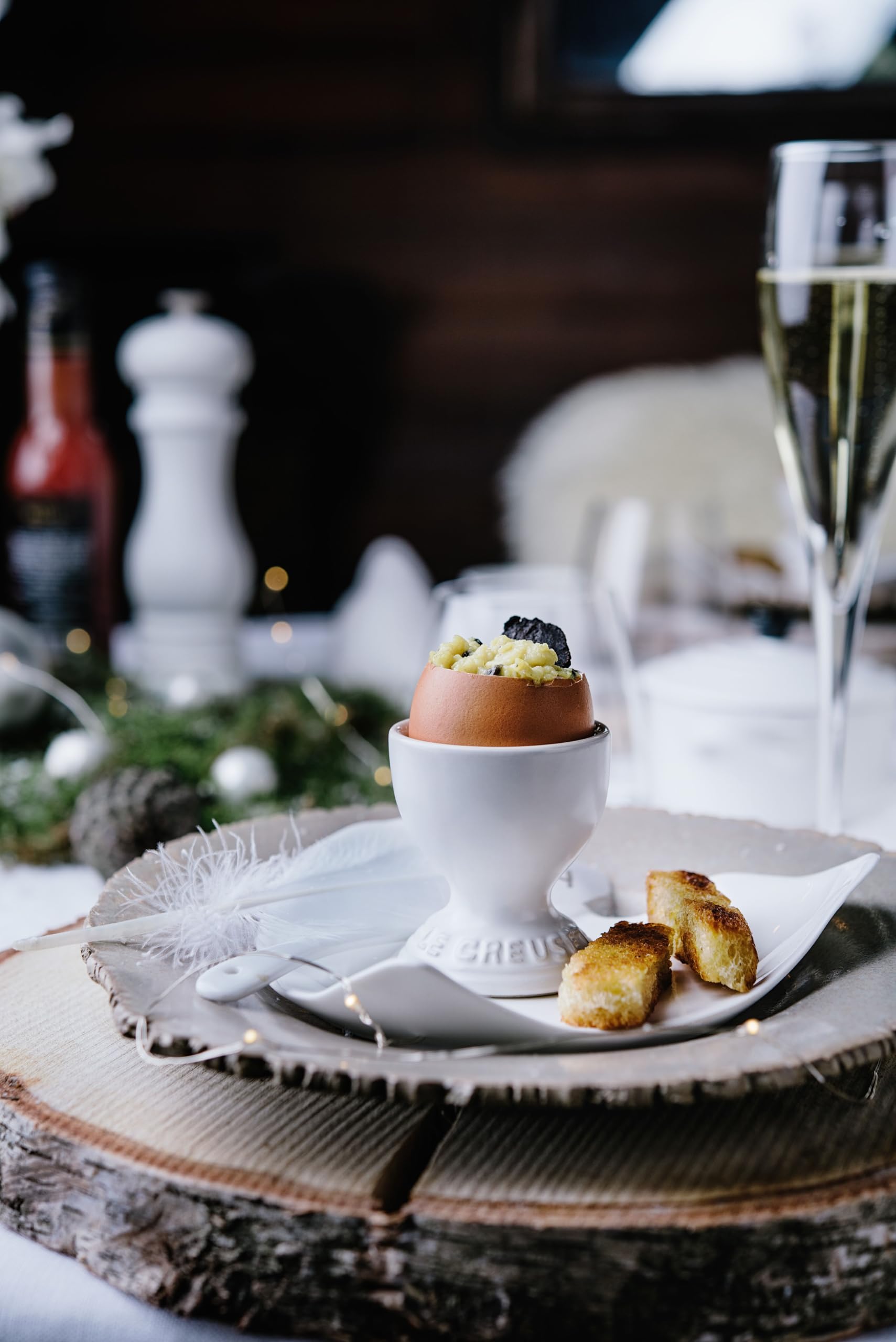 Le Creuset egg cup displayed with Easter eggs and herbs.