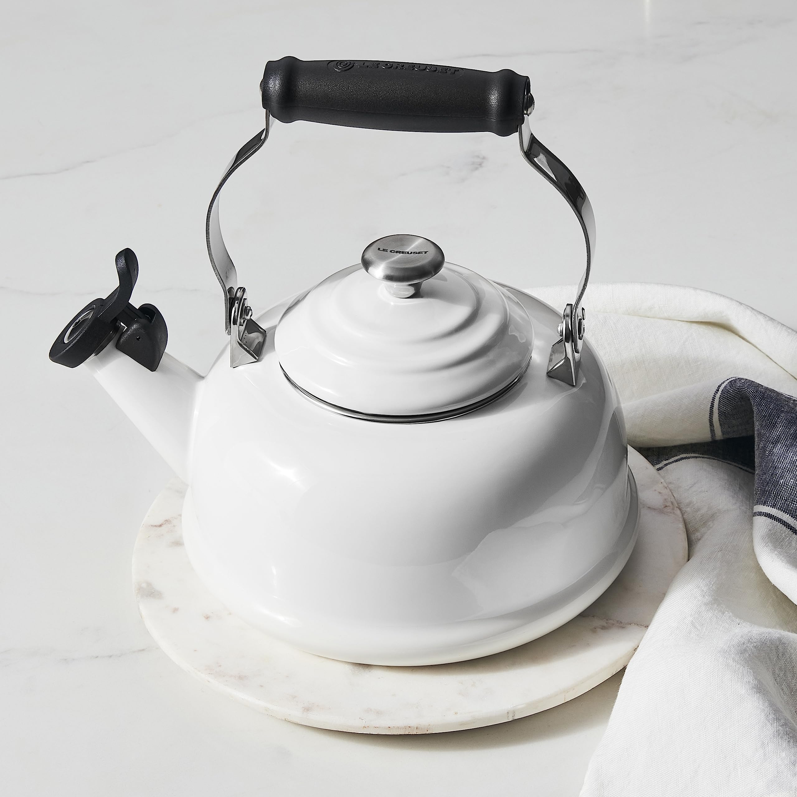 Le Creuset whistling tea kettle knob and handle offer durable grip.