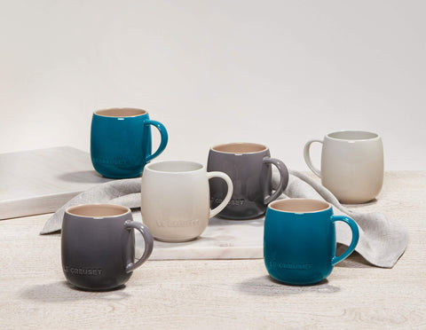 Cerise mugs arranged on a cozy table setting