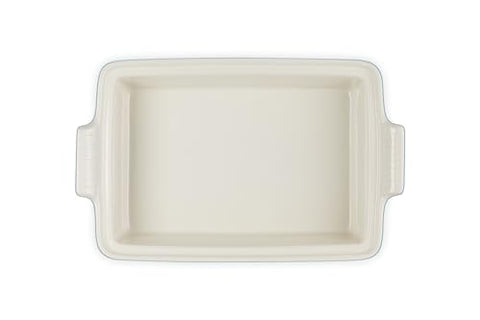 Le Creuset Heritage casserole shown serving from oven to table, versatile for meals.