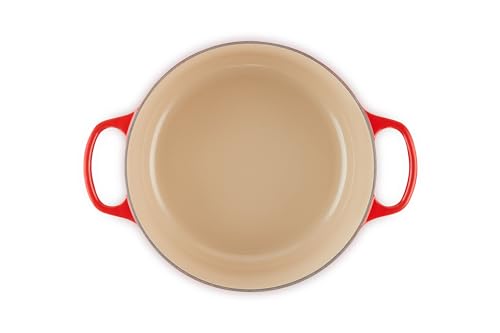 Le Creuset interior enamel shows light color for easy cooking progress checks.