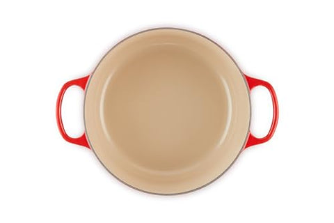 Le Creuset interior enamel shows light color for easy cooking progress checks.