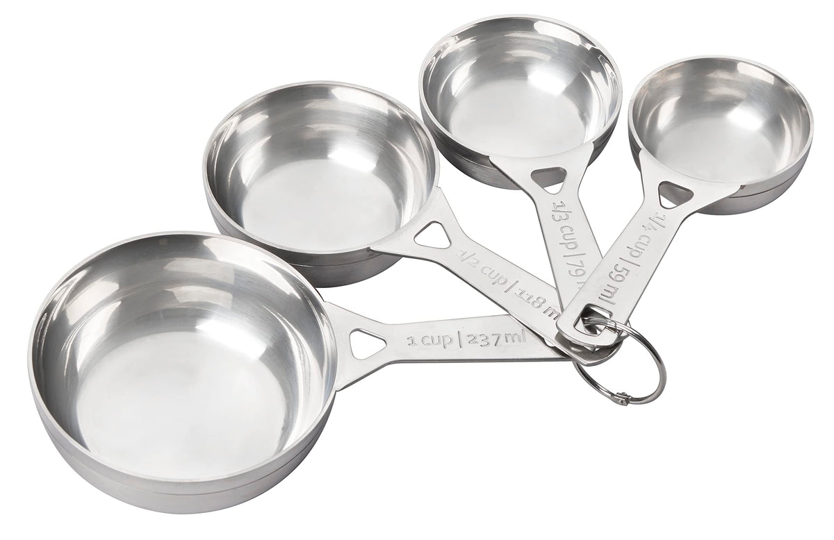 Le Creuset quarter-cup measuring cup for precise dry ingredient measures in baking.