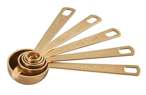 Le Creuset gold measuring spoon 1tsp convenient for recipe prep.