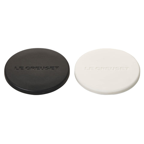 Le Creuset mill caps in black and white fit 8-inch mills and help keep counters clean.