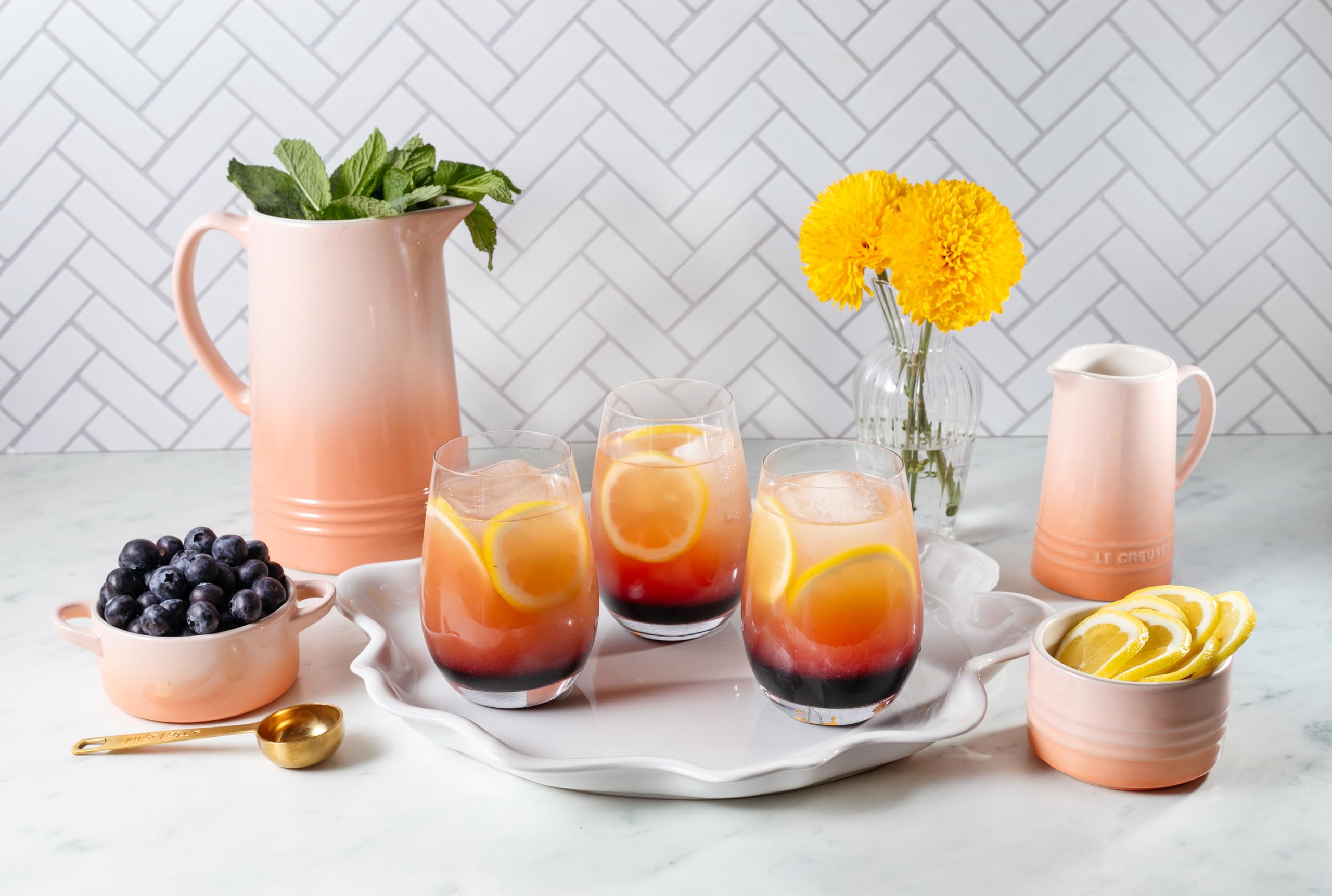 Le Creuset Peche cocotte serves as a prep dish or decorative accent.
