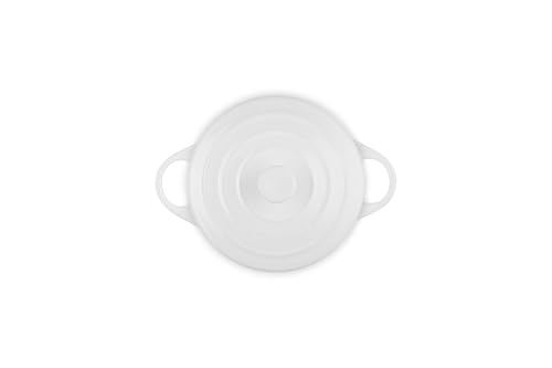 Le Creuset mini round cocotte side handles provide secure grip during transport.