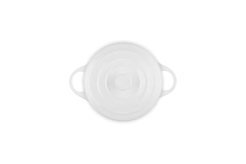 Le Creuset mini round cocotte side handles provide secure grip during transport.