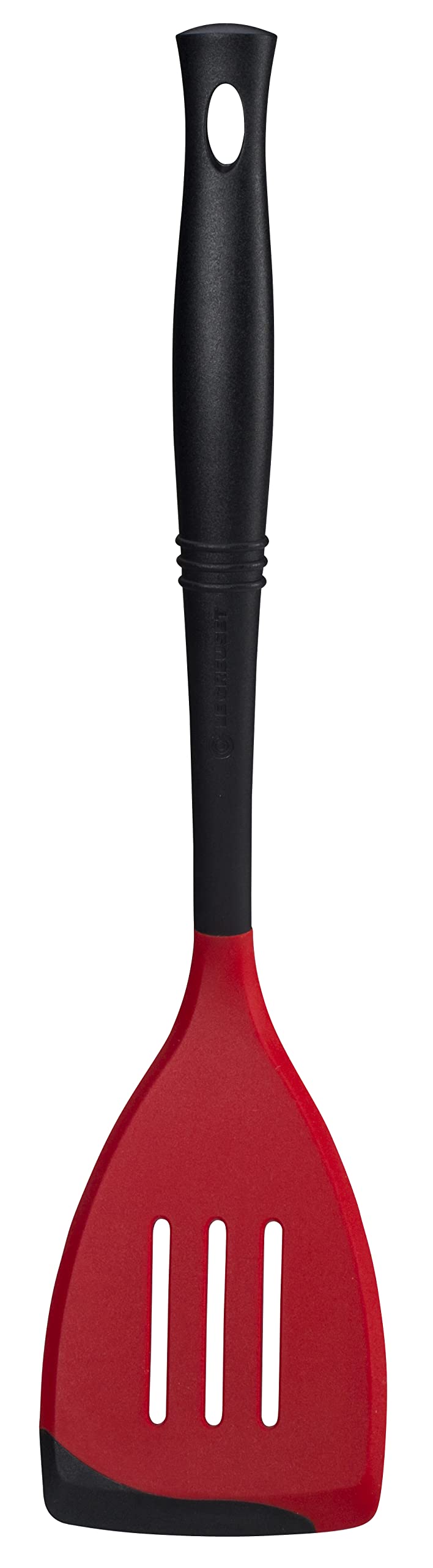 Le Creuset Revolution bi-material slotted spatula head for sturdy lifting.