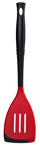 Le Creuset Revolution bi-material slotted spatula head for sturdy lifting.